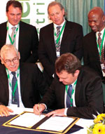 Actom’s Jack Rowan (l) and Carl Kleynhans sign the partnership agreement. Behind them are Frederic Abbal, Mark Wilson and Andries Tshabalala.